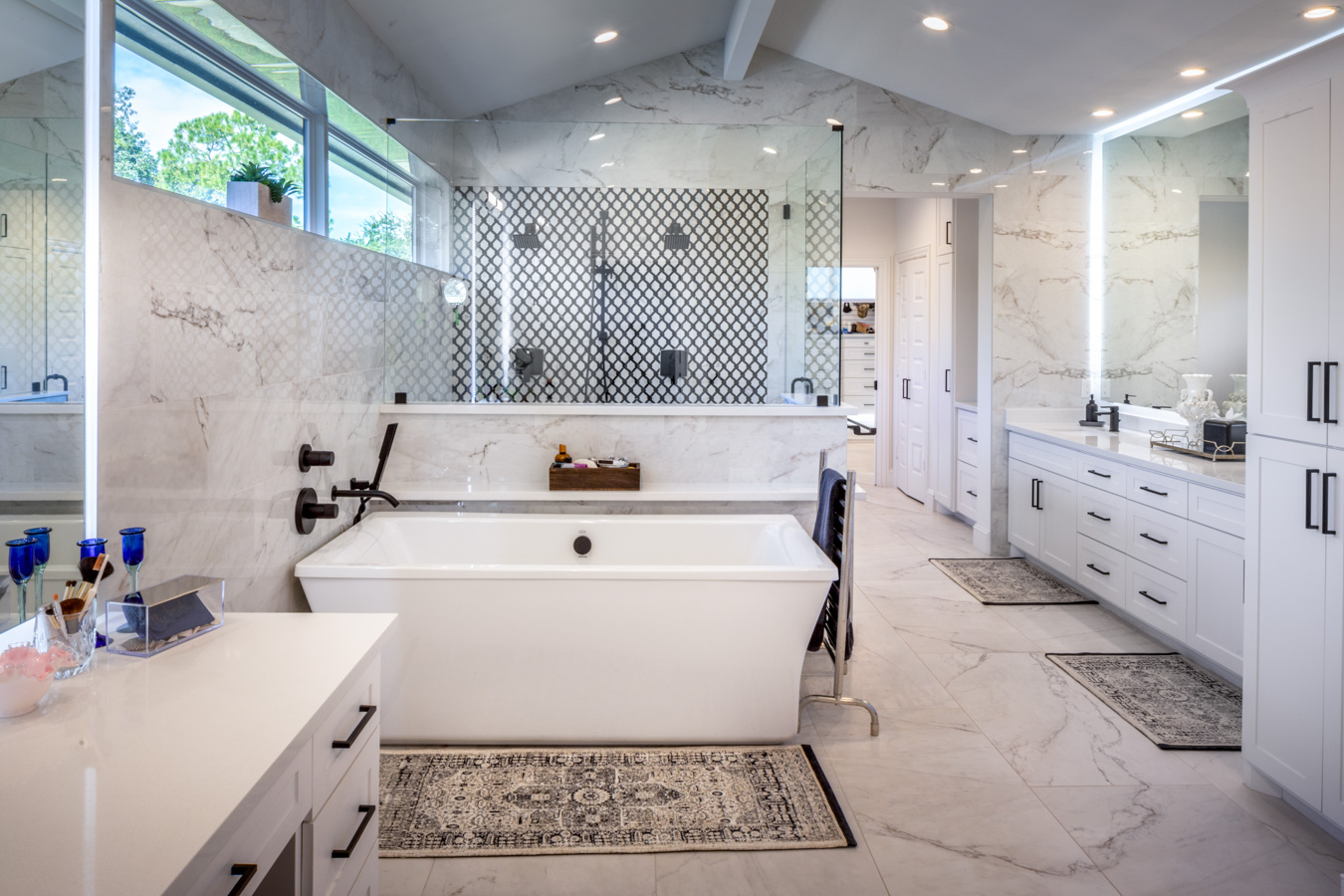 A bathroom with a bathtub , sink , mirror and shower.