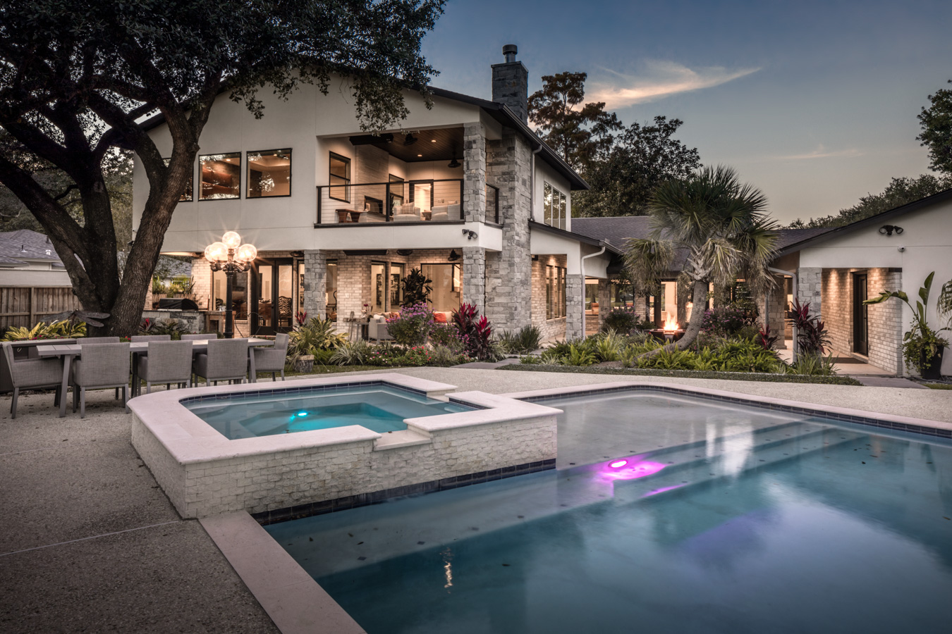 A large house with a large swimming pool in front of it