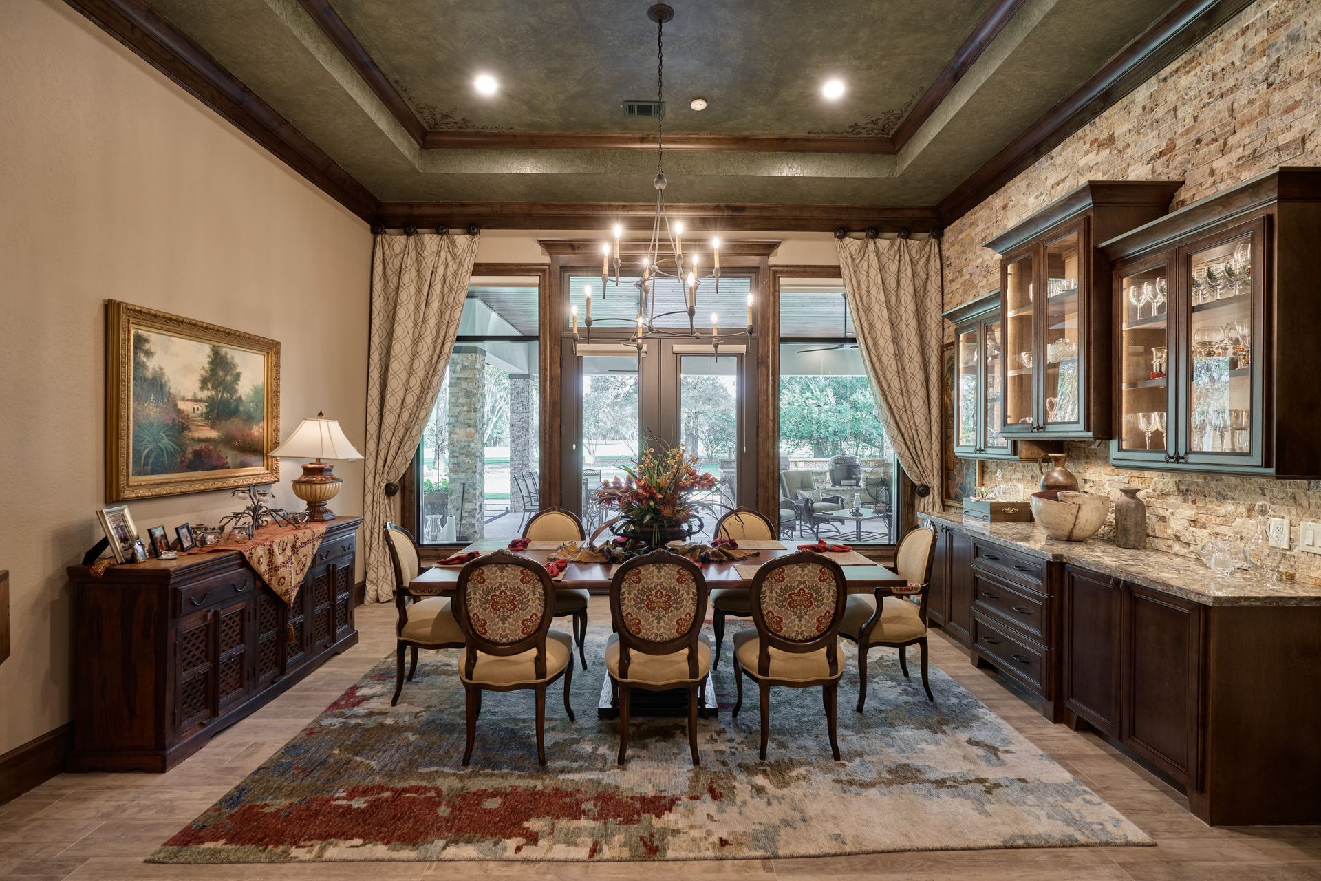 A dining room with a table and chairs and a rug.