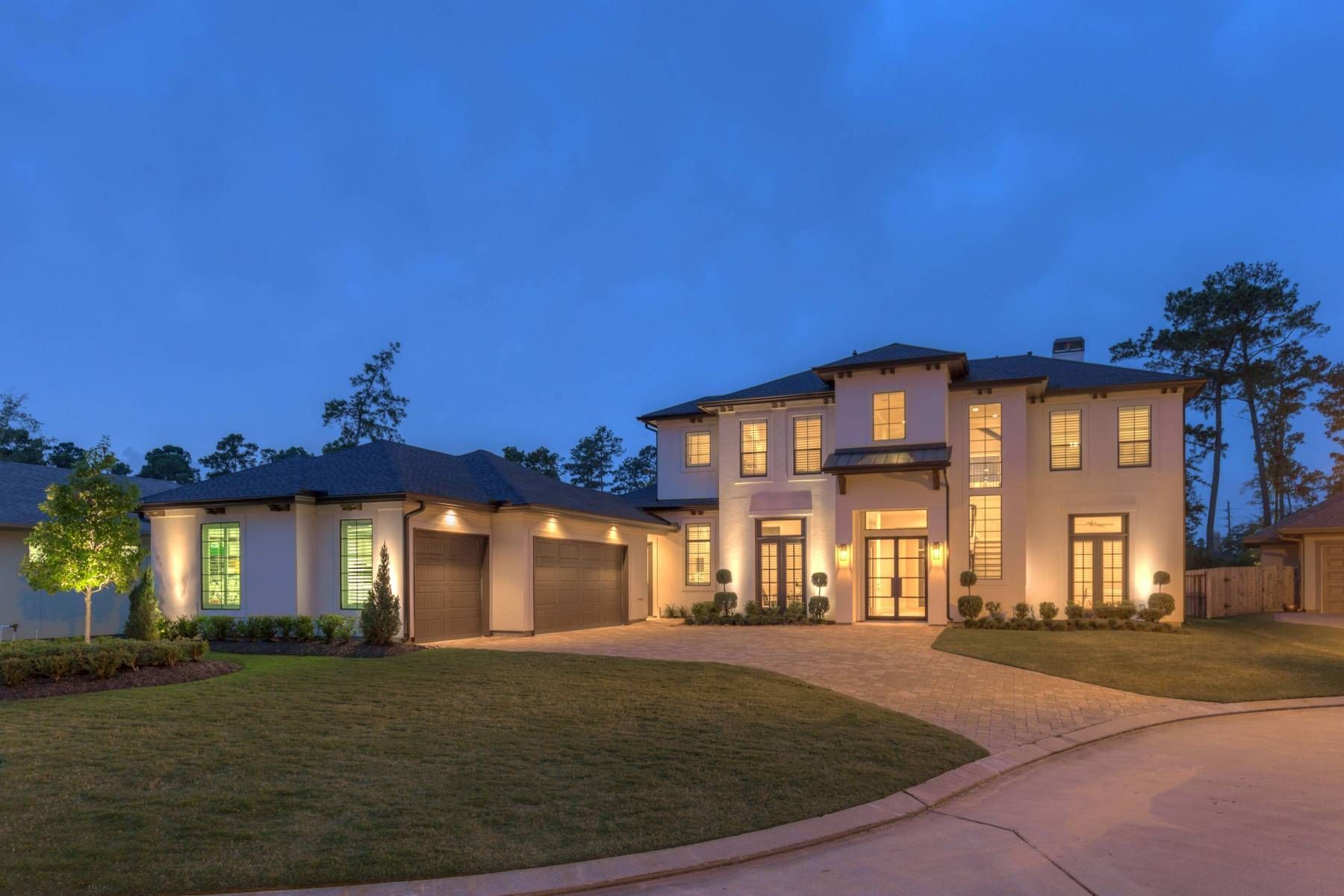 A large white house is lit up at night