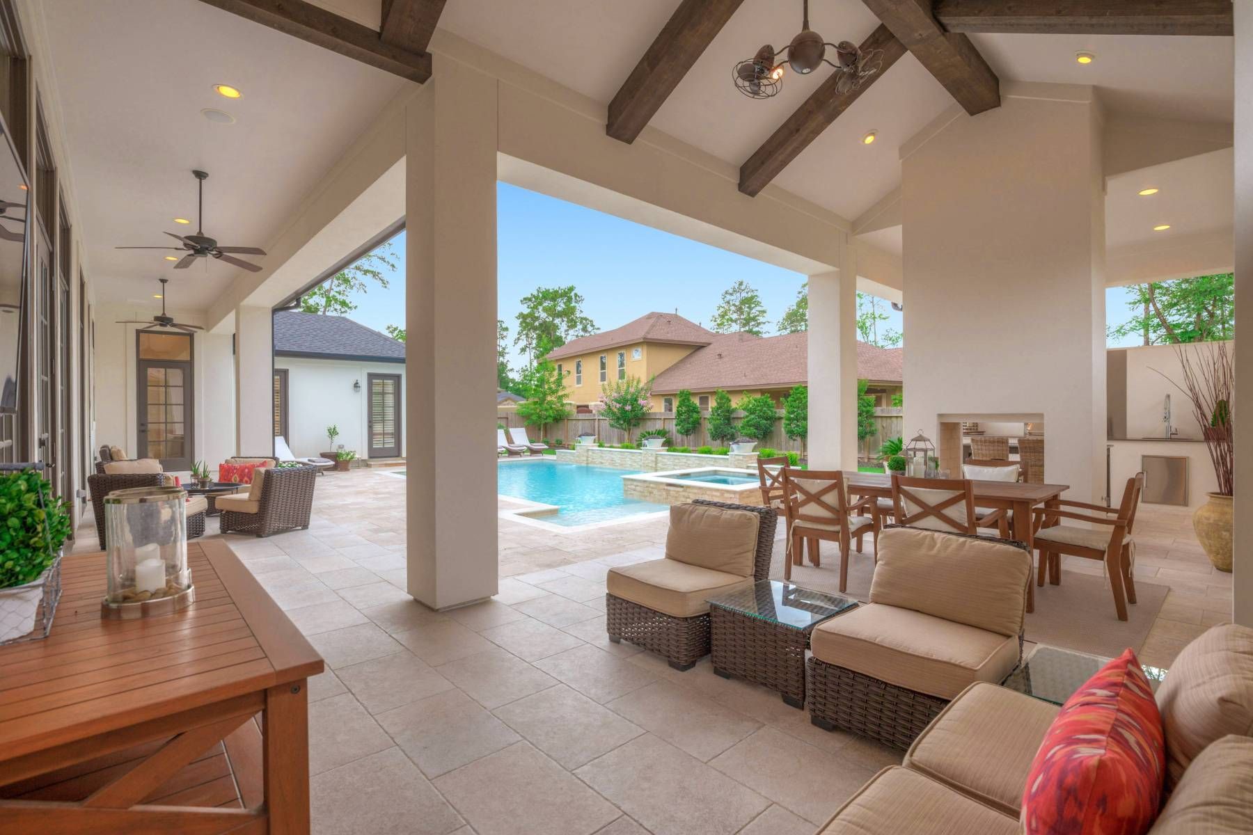 A living room with a couch , chairs , a table and a ceiling fan.