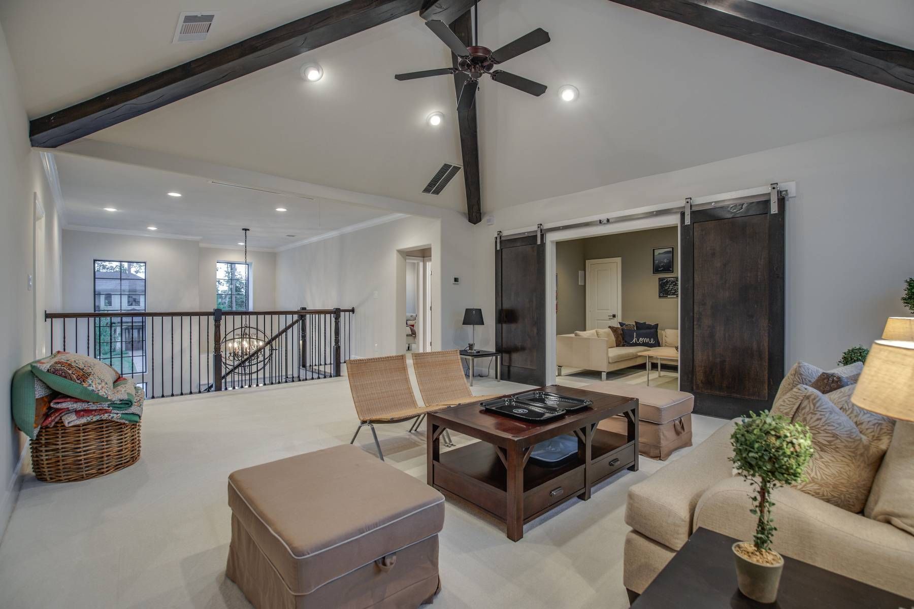 A living room filled with furniture and a ceiling fan.