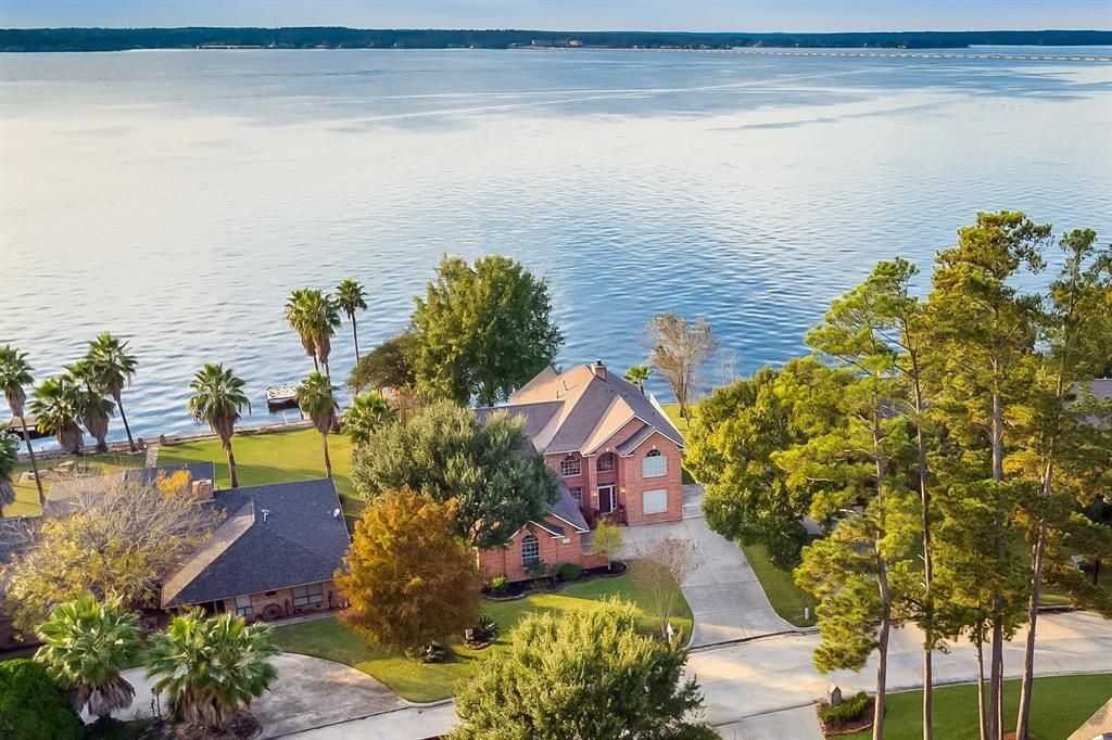 An aerial view of a house next to a body of water.