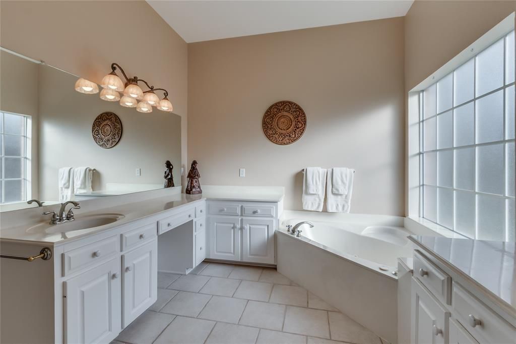 A bathroom with two sinks and a bathtub