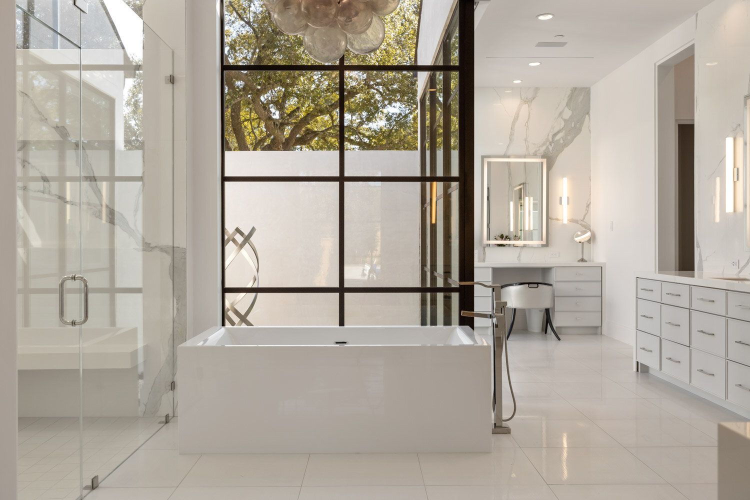 A bathroom with a bathtub and a large window.
