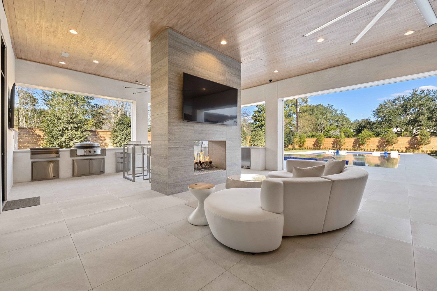 A living room with a fireplace and a flat screen tv.