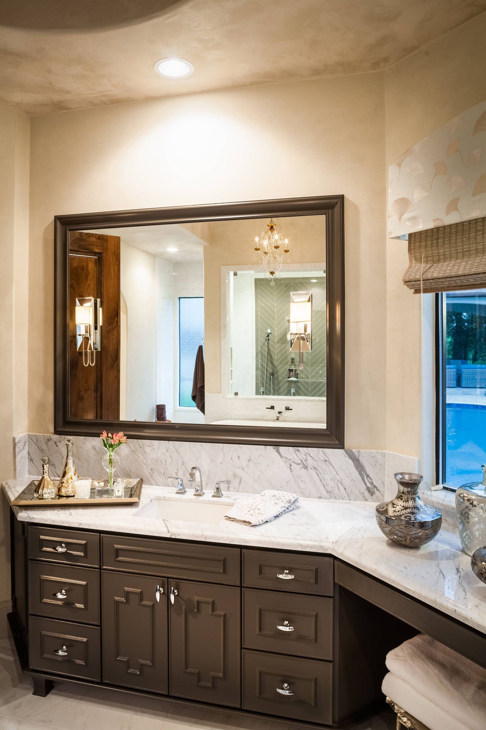 A bathroom with two sinks , a large mirror and a window.