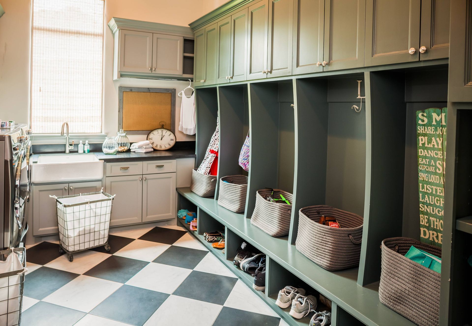 A laundry room with lots of shelves and baskets and a checkered floor.