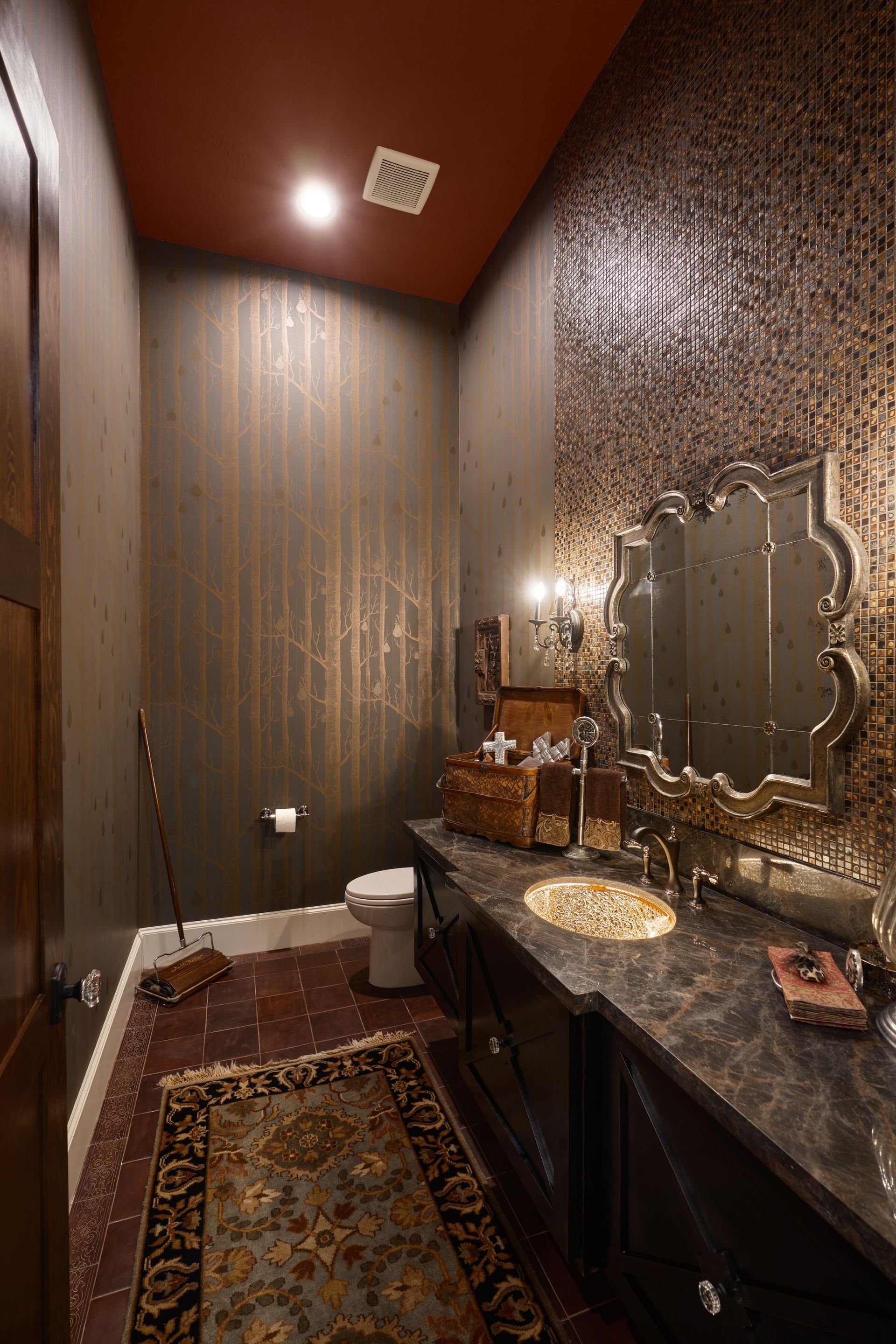 A bathroom with a toilet , sink and mirror