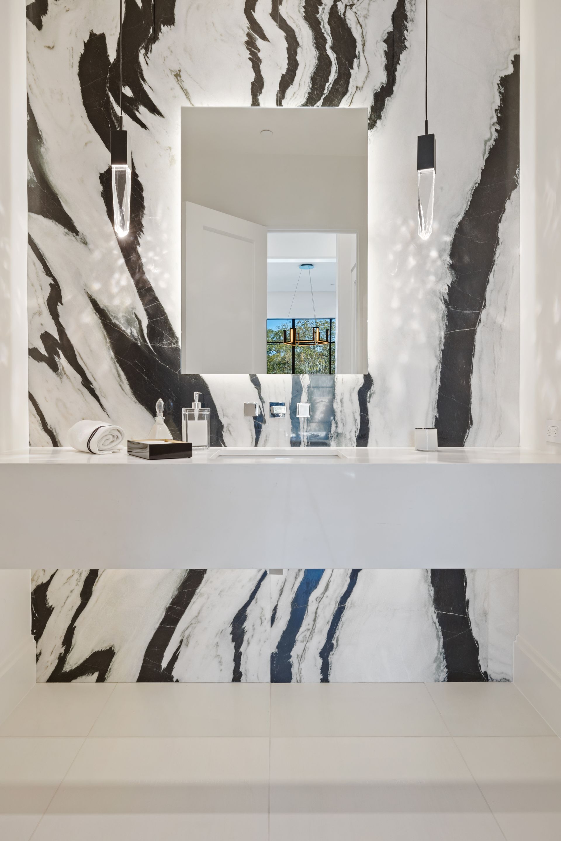A bathroom with a sink and a mirror with a zebra print on the wall.