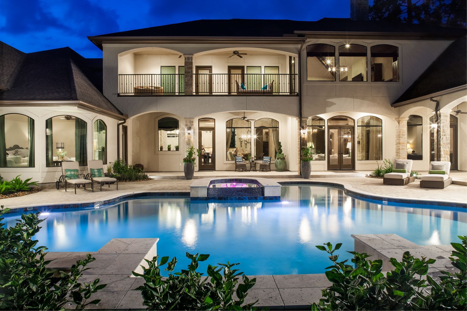 A large house with a large swimming pool in front of it