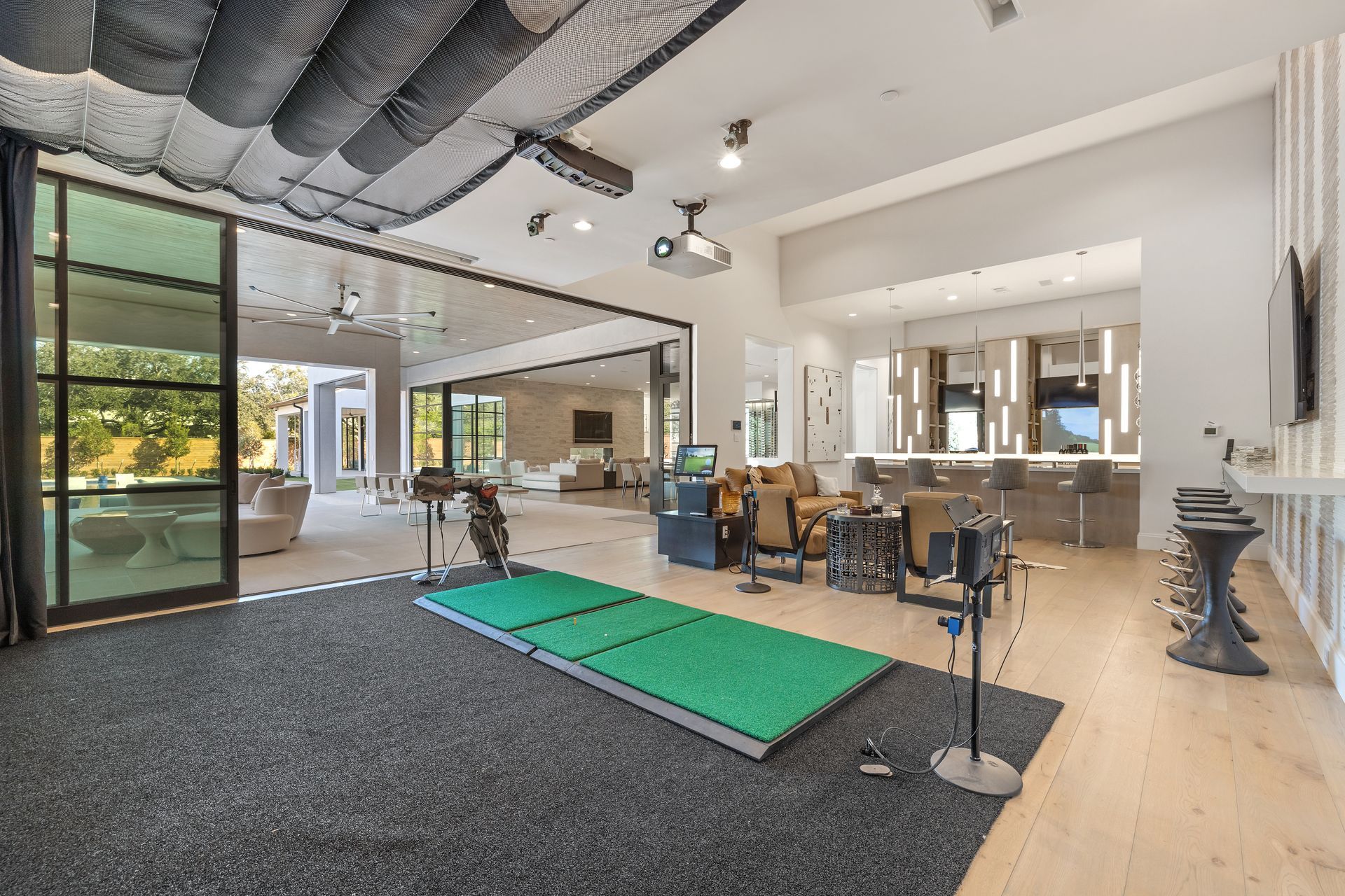 There is a golf mat in the middle of the room.