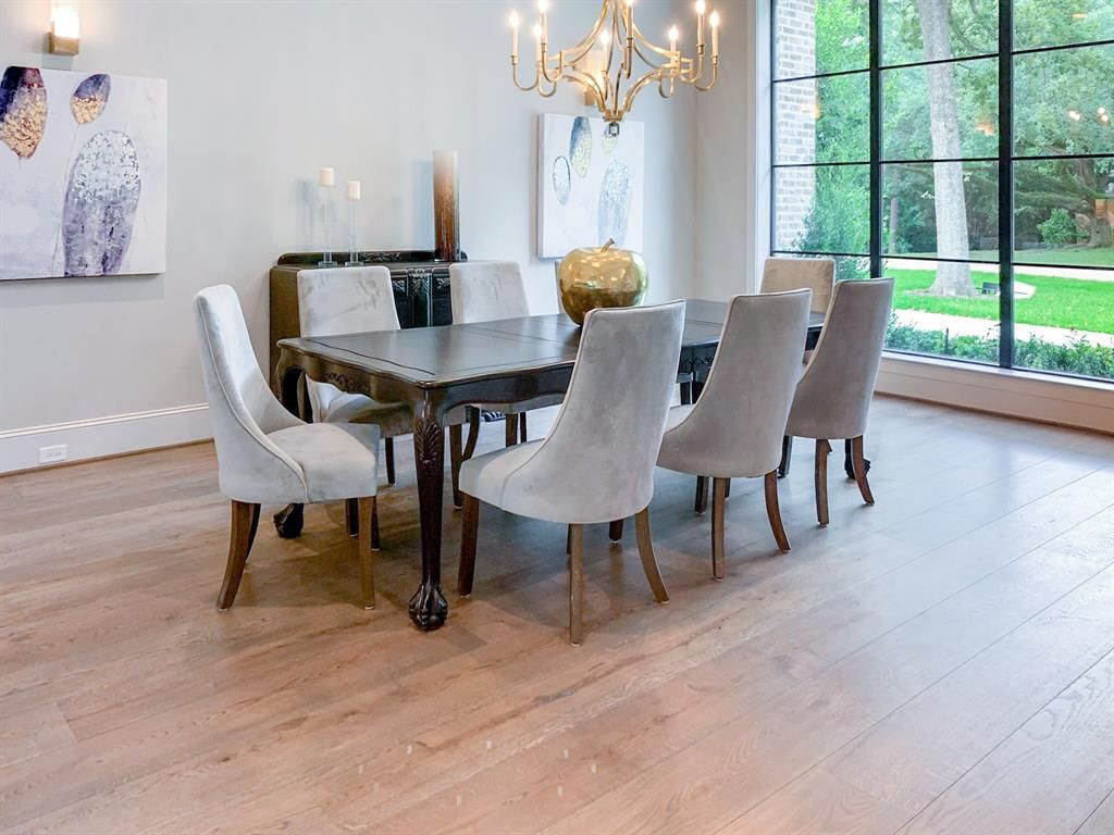 A dining room with a table and chairs and a chandelier.