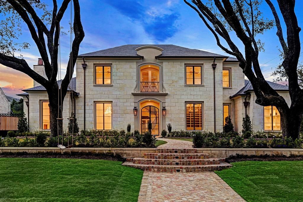 A large house with a lot of windows and trees in front of it.