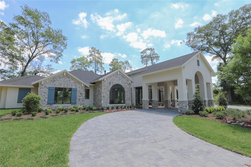 A large white house with a driveway leading to it