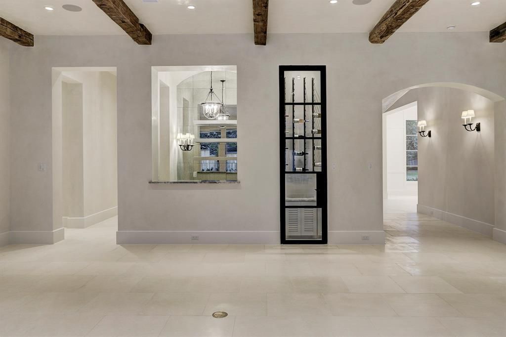 An empty room with a shelf in the middle of it