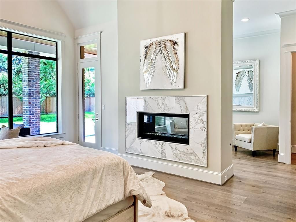 There is a fireplace in the middle of the bedroom.