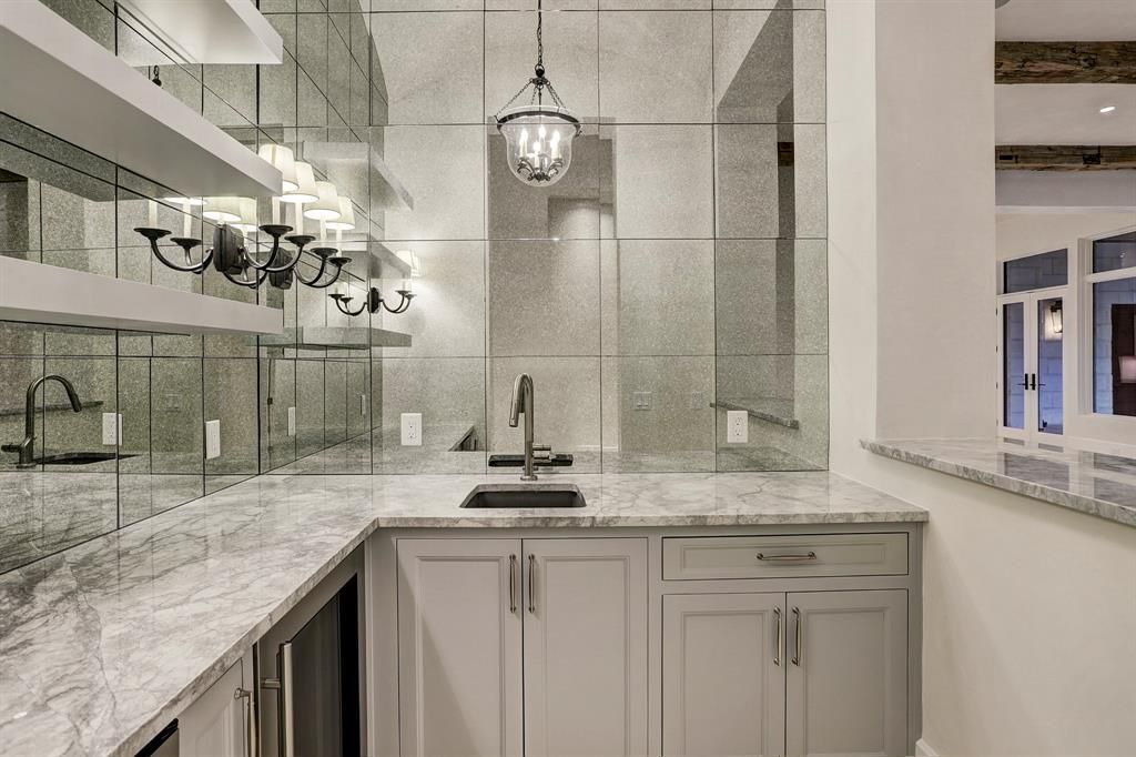 A kitchen with white cabinets , granite counter tops , and a sink.