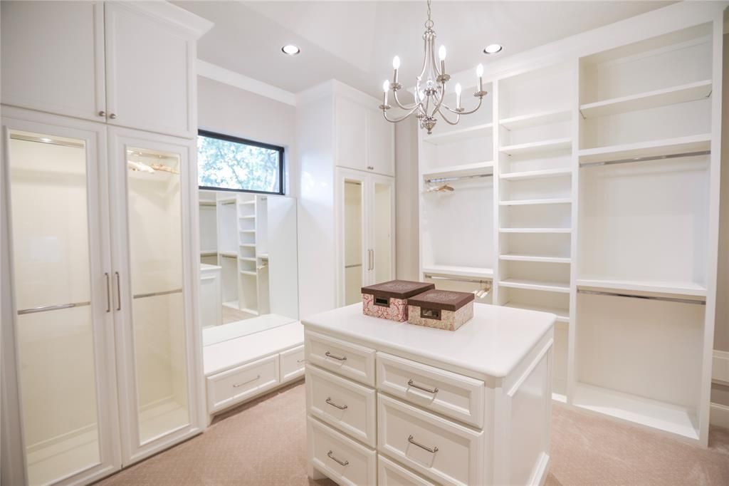 There is a large island in the middle of the walk in closet.