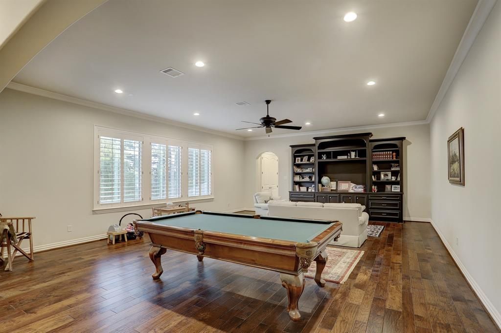 There is a pool table in the middle of the room.