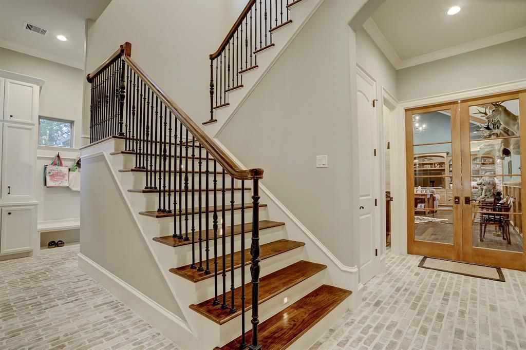 A staircase with wooden steps and a metal railing in a house.