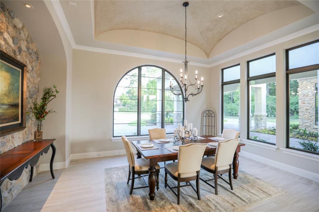 A dining room with a table and chairs and a chandelier.