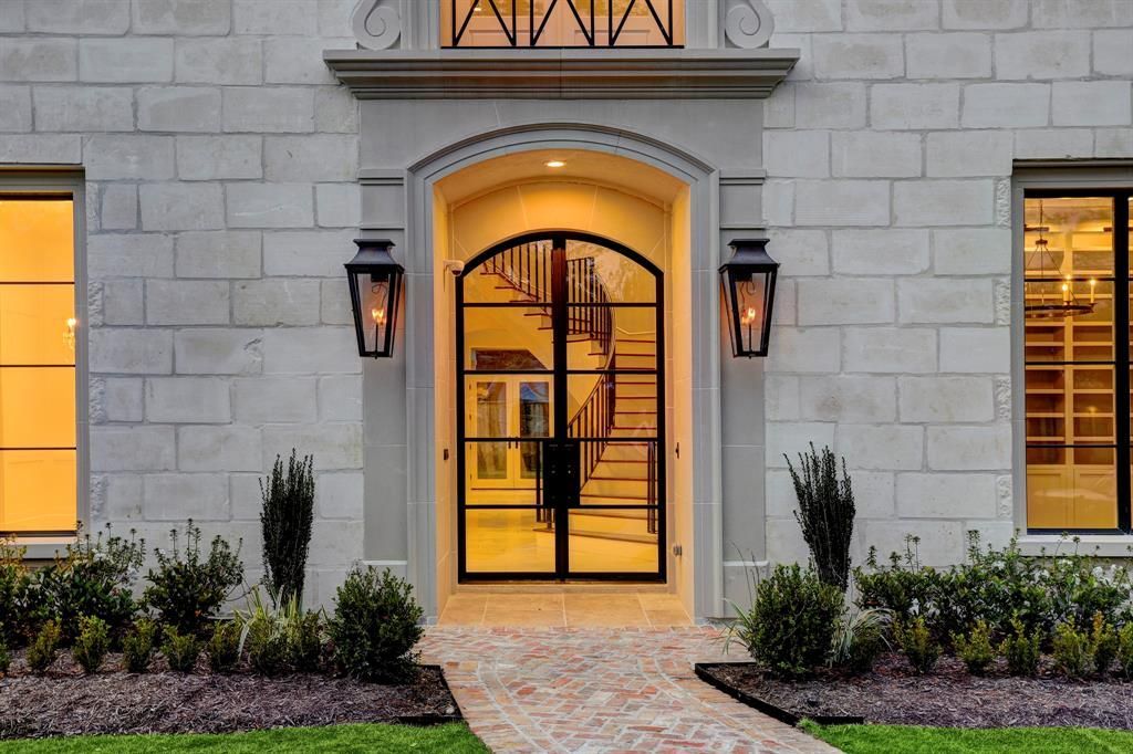 The front door of a large brick building with a walkway leading to it.