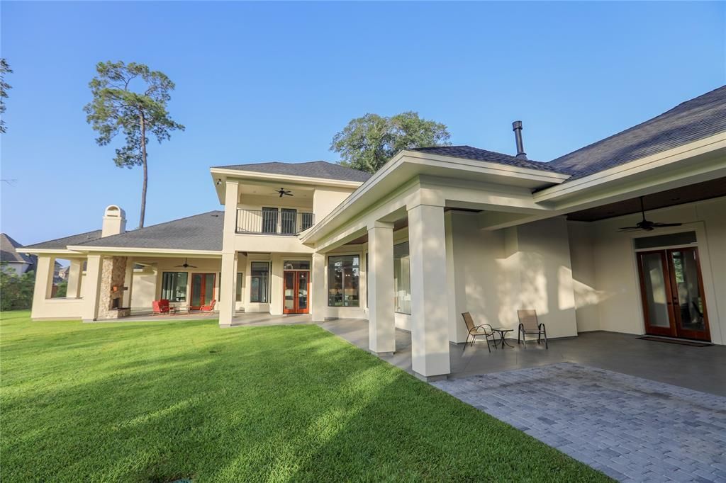 A large white house with a large lawn in front of it.
