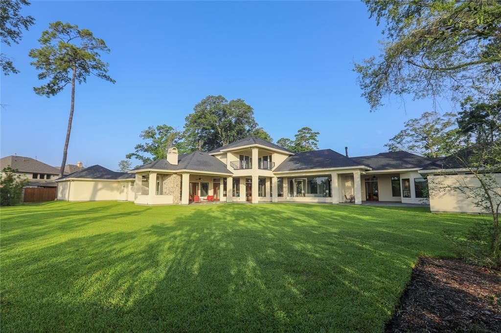 A large house with a large lawn in front of it.