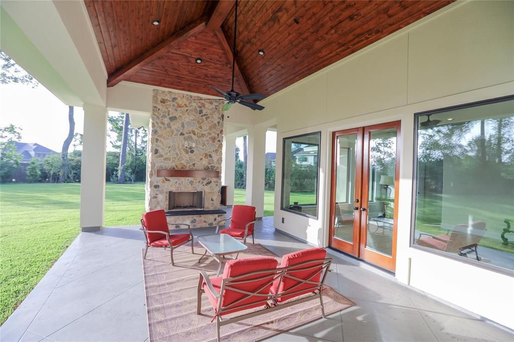 There is a patio with a fireplace and a lot of windows.