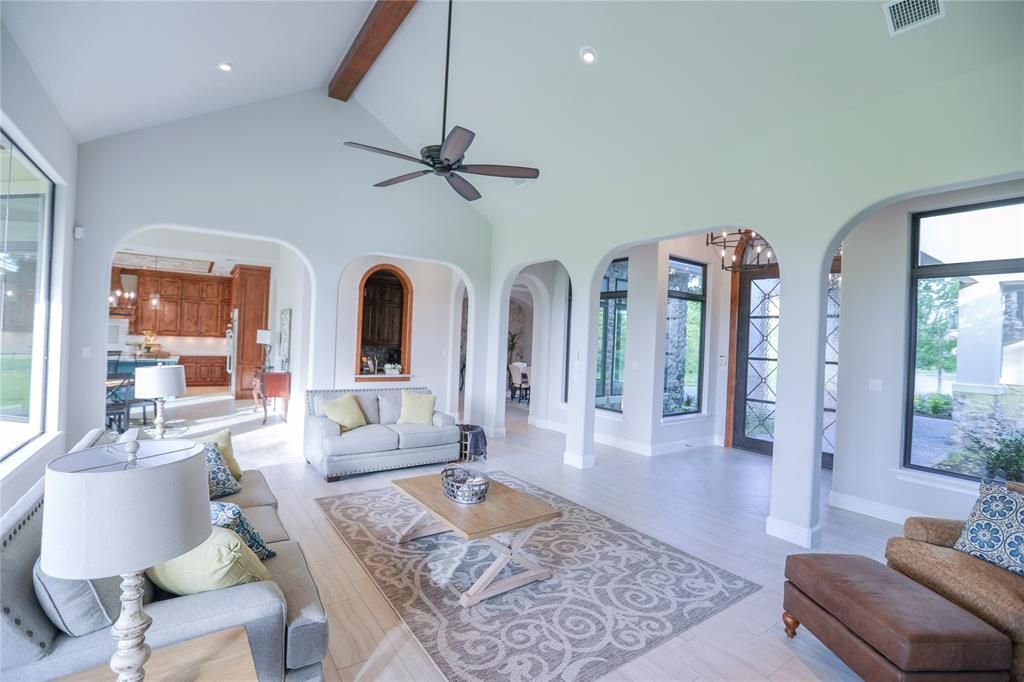 A living room filled with furniture and a ceiling fan.