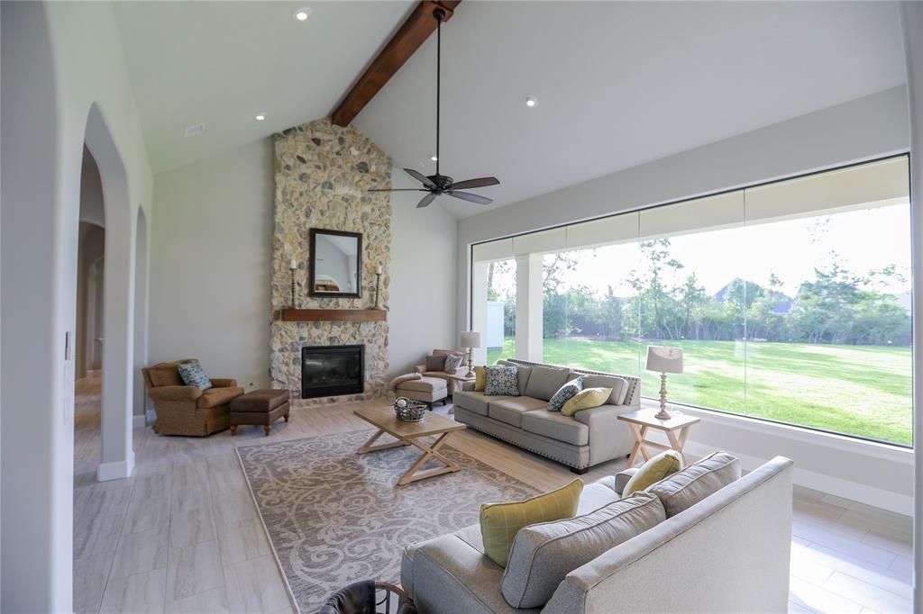 A living room with a couch , chairs , and a fireplace.