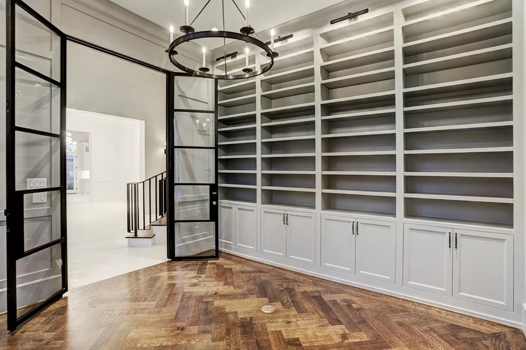 A large room with a lot of shelves and a chandelier.