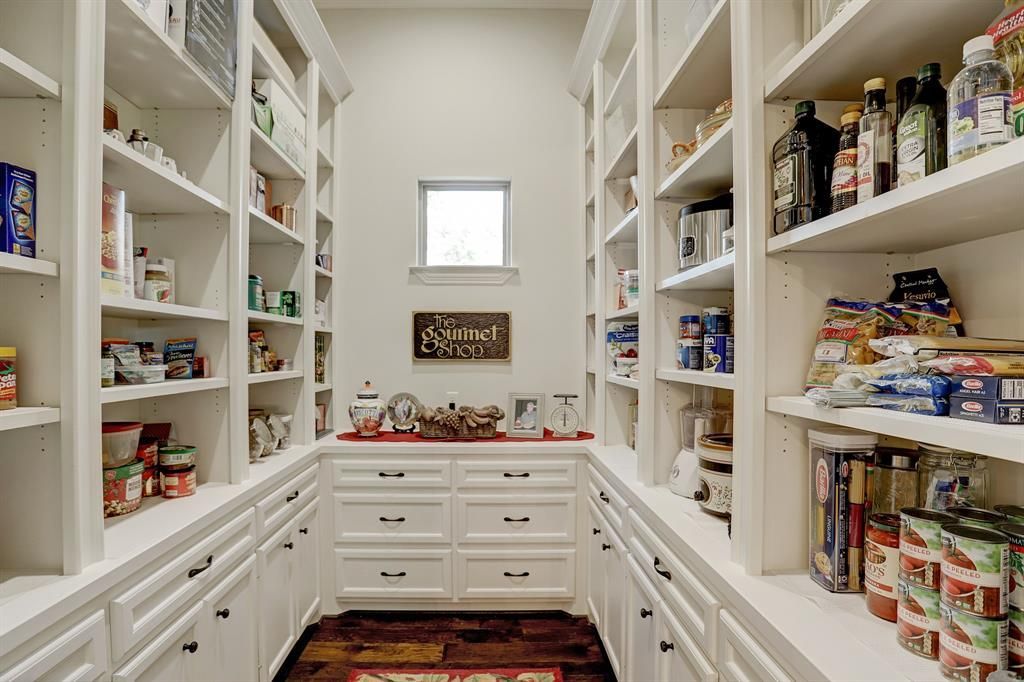 A pantry filled with lots of food and a window.