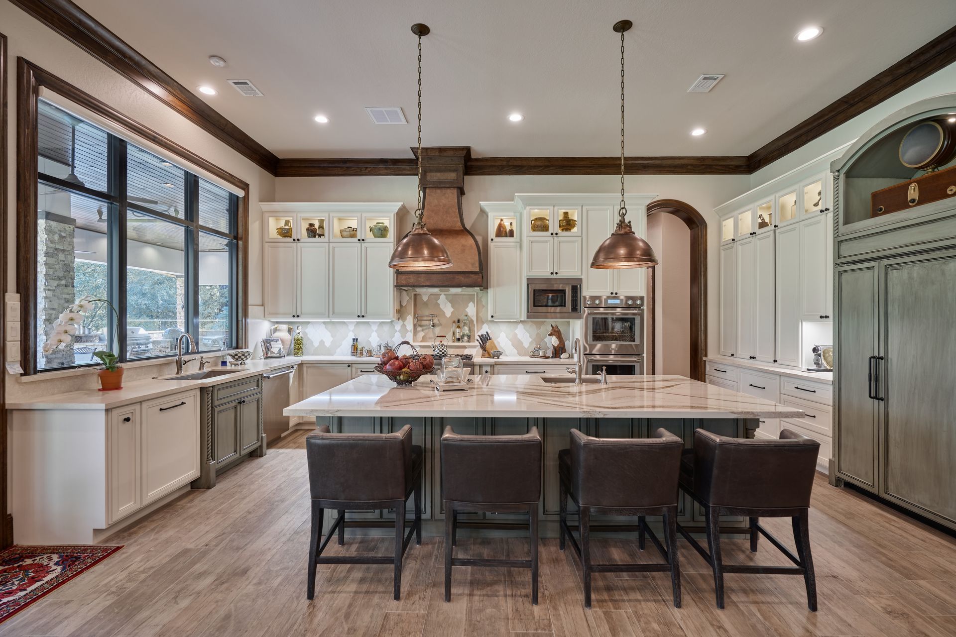 A large kitchen with a large island and stools.