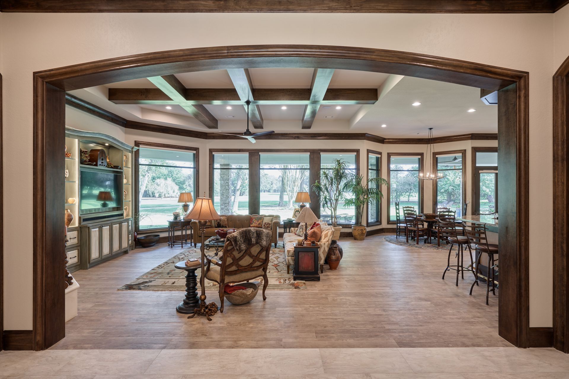 A large living room with a lot of furniture and a lot of windows.