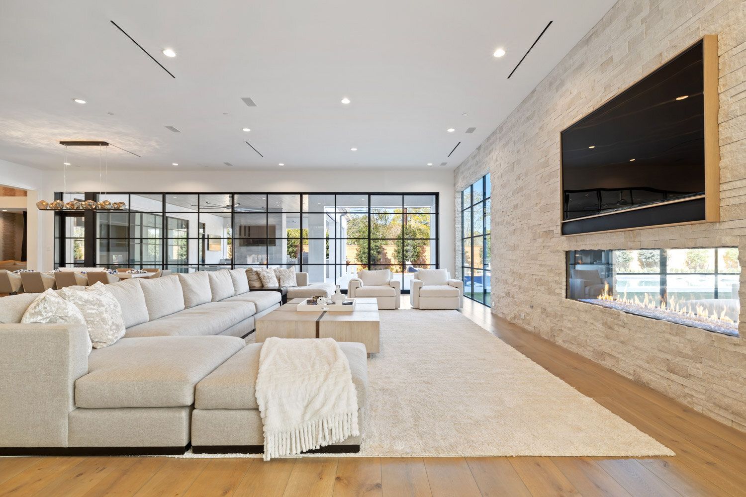 A living room with a large sectional couch and a flat screen tv.