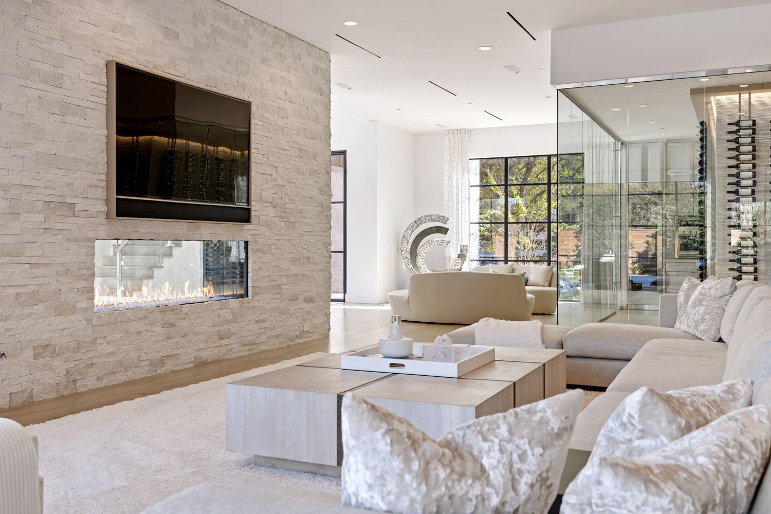 A living room with a couch , coffee table , fireplace and television.