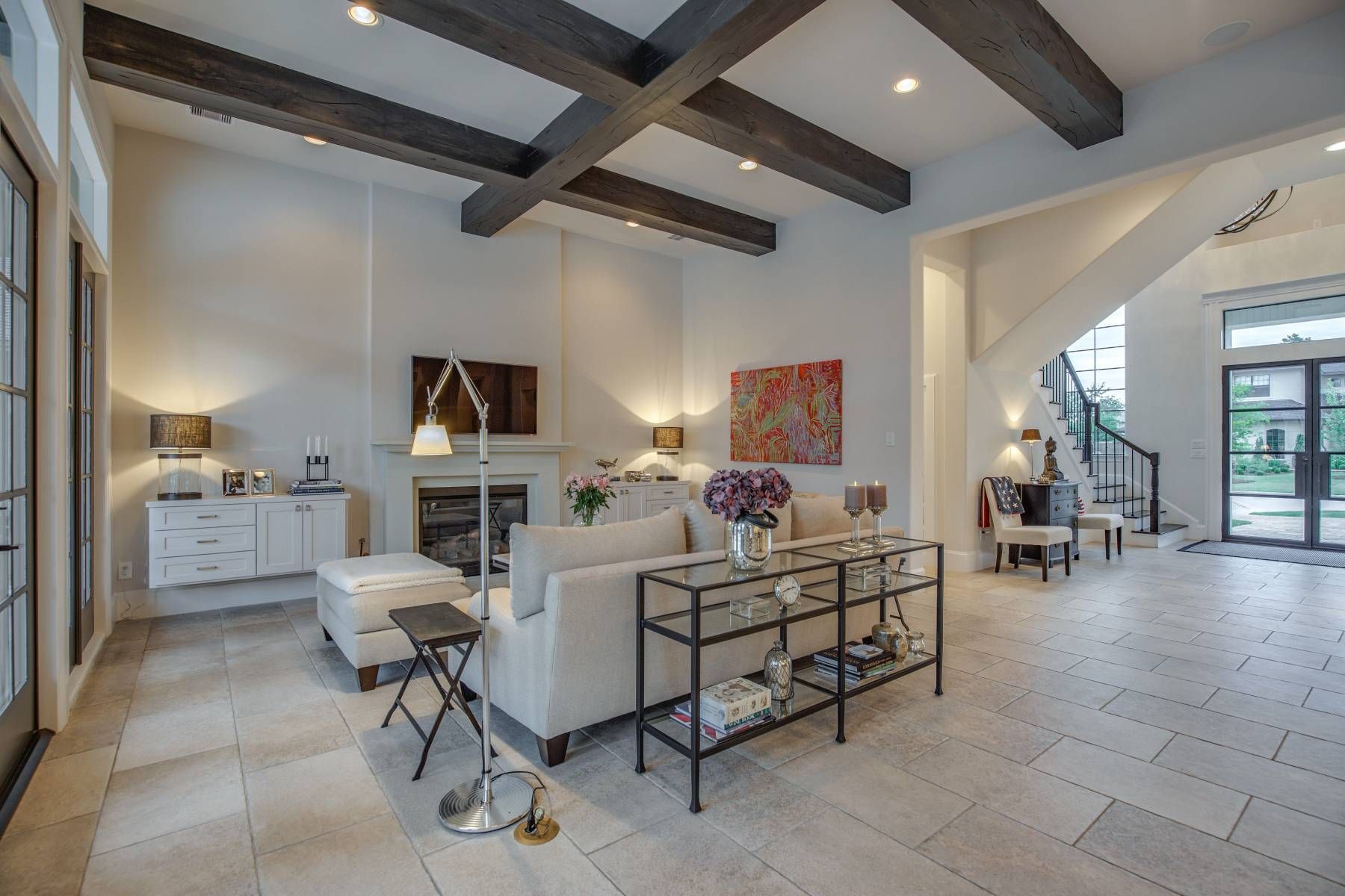 A living room with a couch , chairs , and a fireplace.