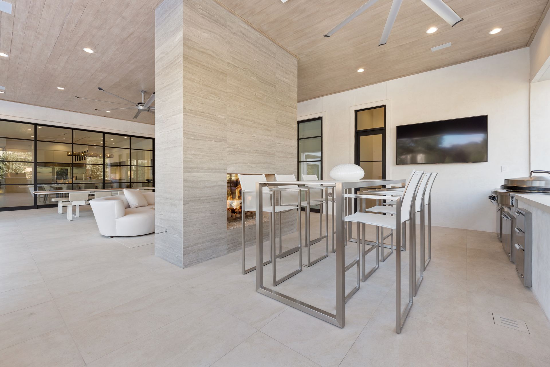 There is a table and chairs in the middle of the room.