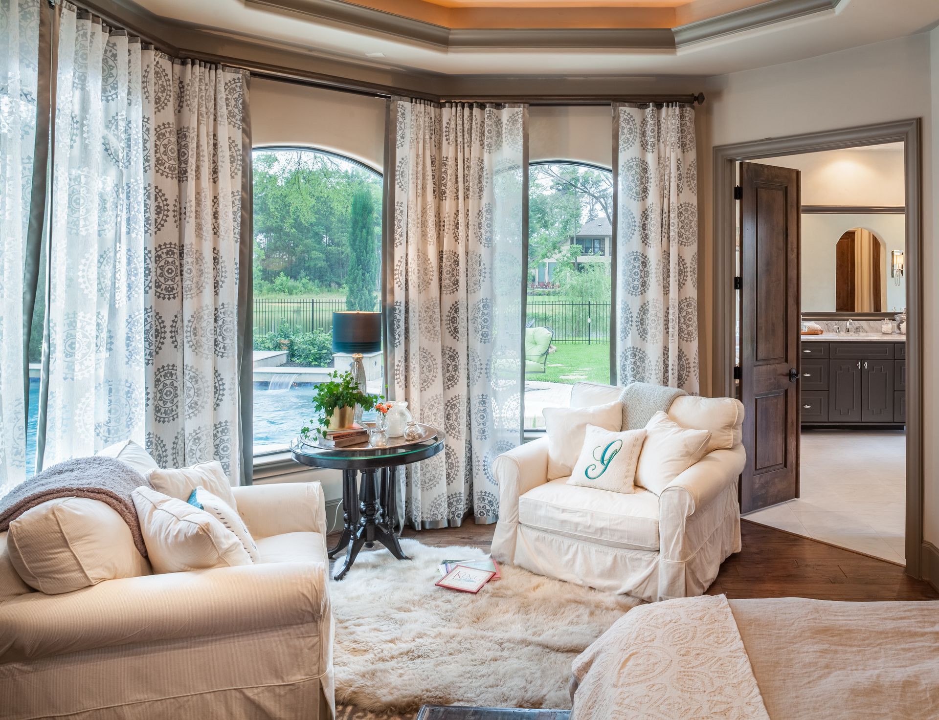 A living room with a couch , chair , table and window.
