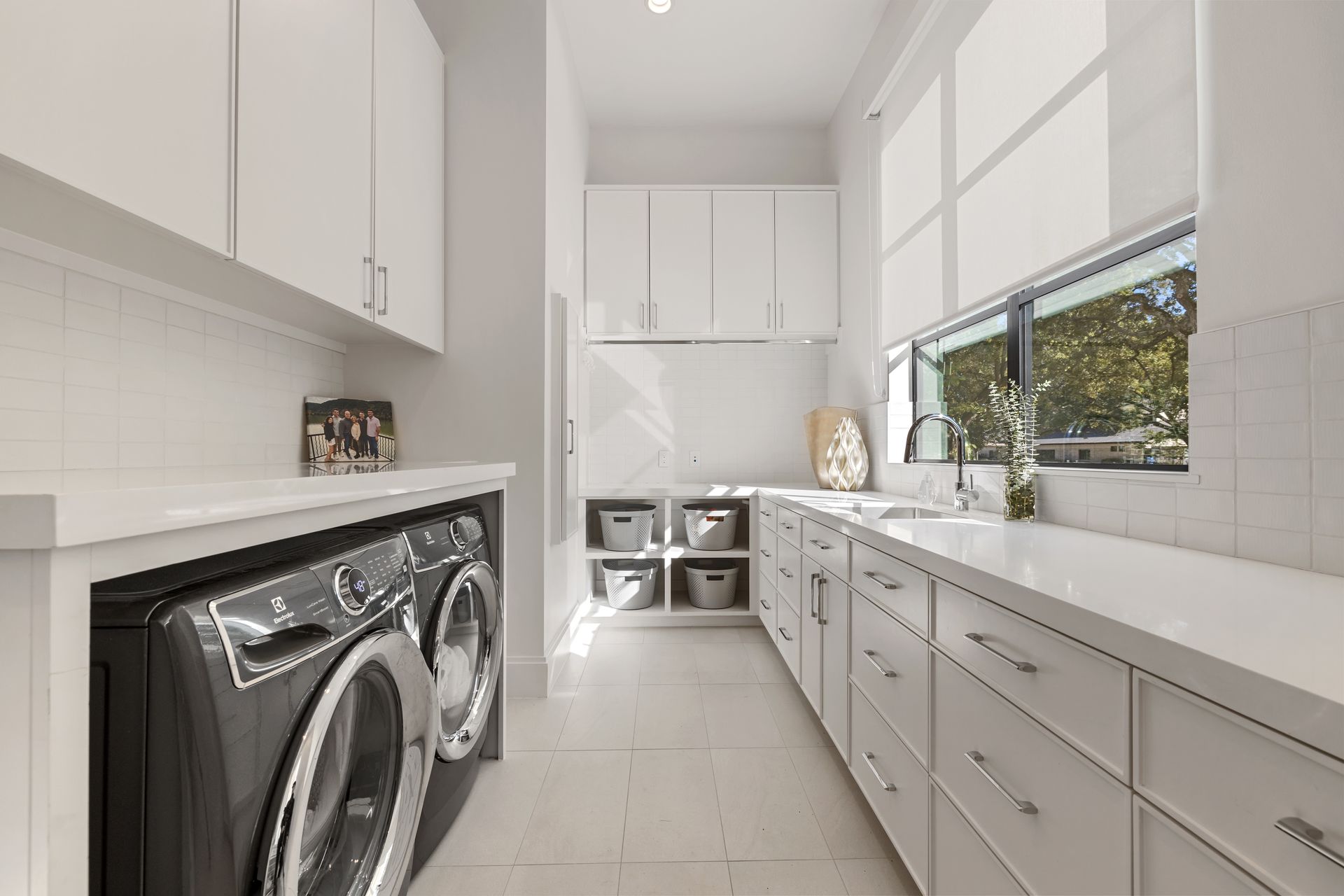 A laundry room with a washer and dryer and a sink.