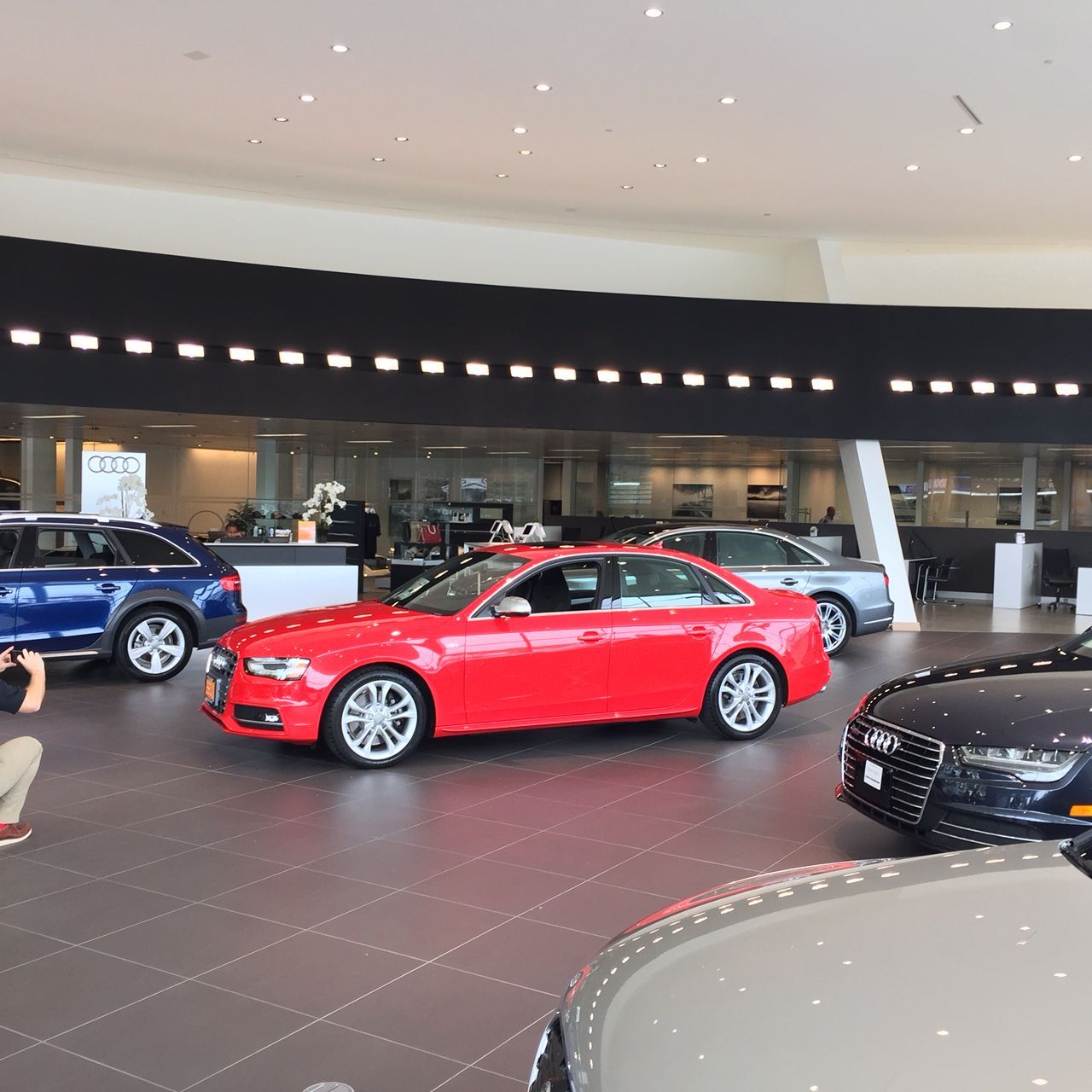 An aerial view of a parking lot with cars parked on the roofs of buildings.