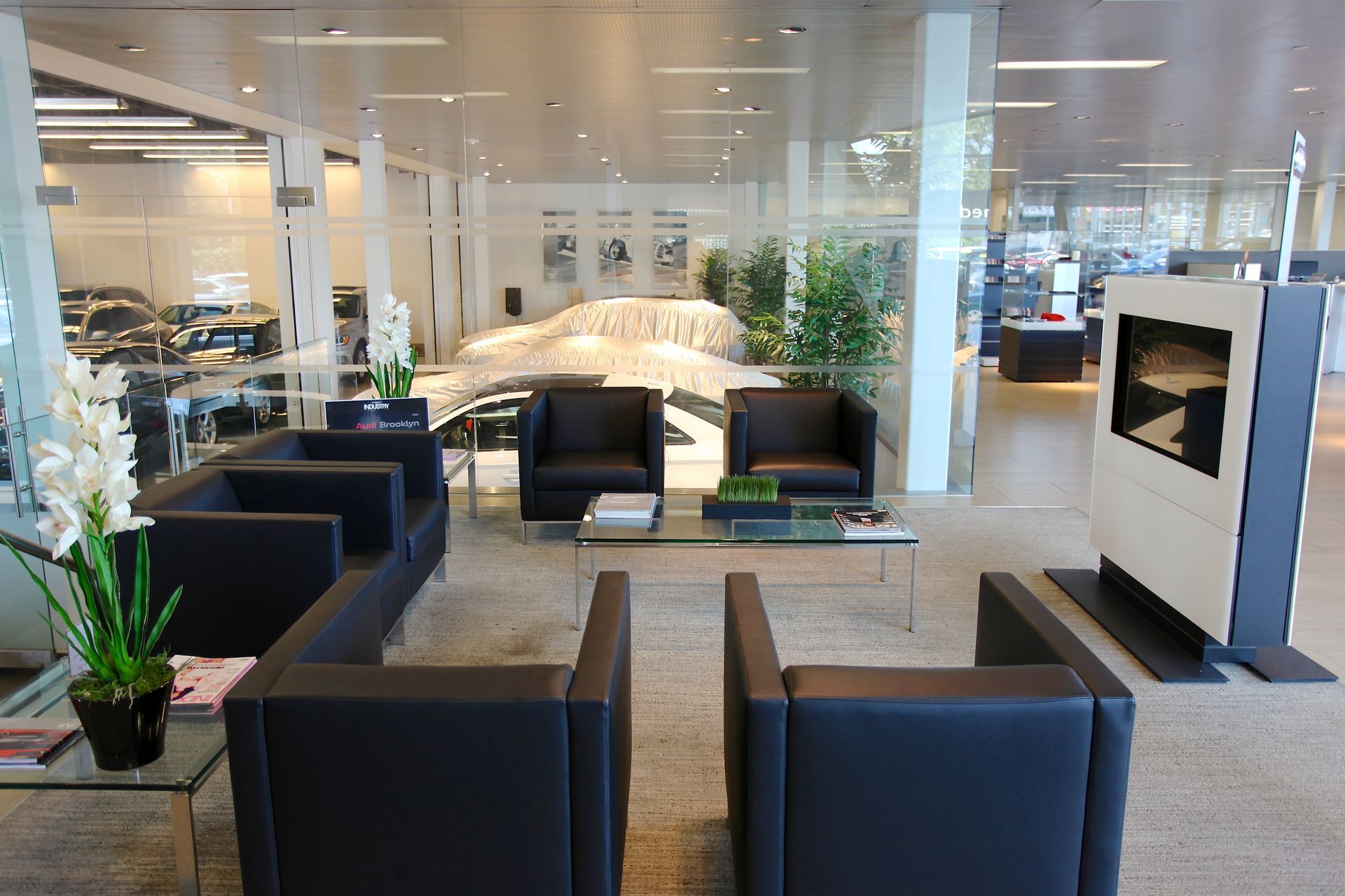 A woman in a green shirt is laughing with her mouth open