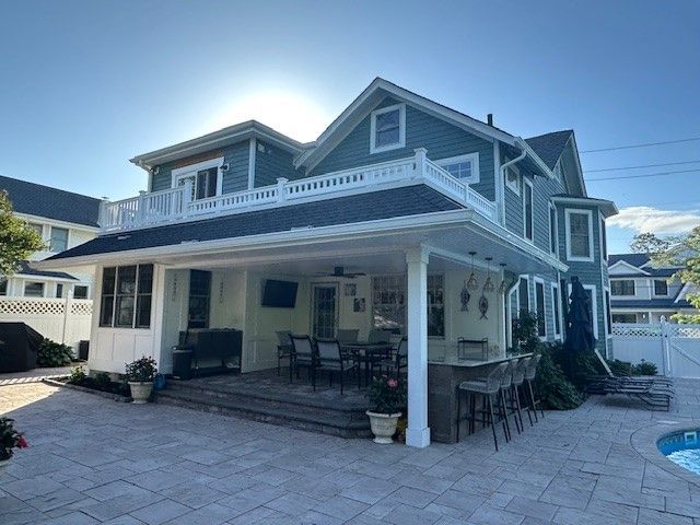 A large house with a garage and a car parked in front of it.