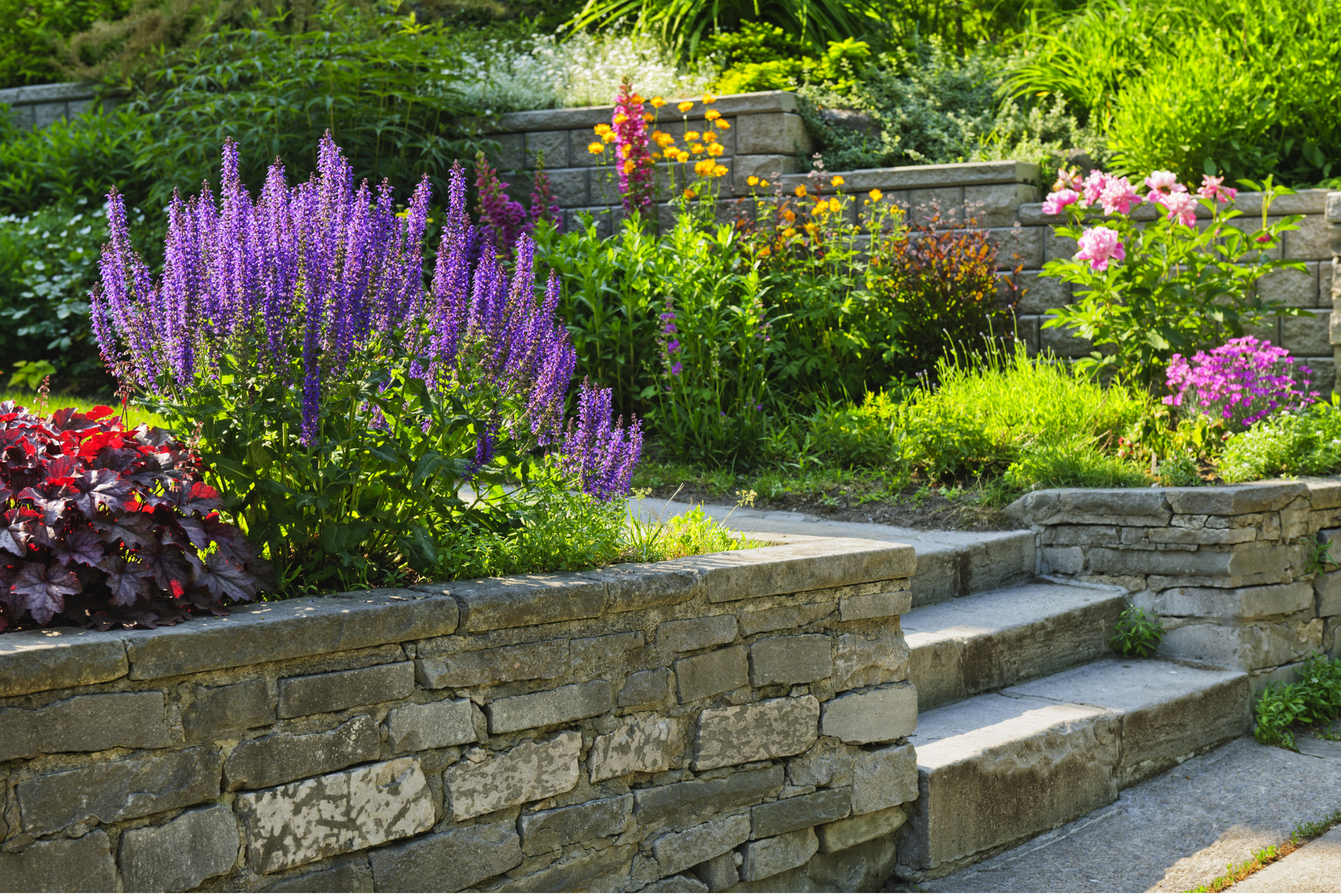 Retaining walls and concrete curbing with flowers in the garden.