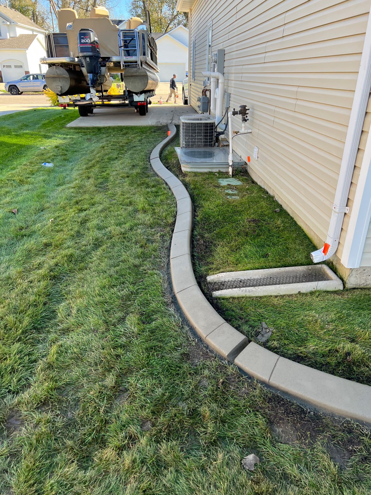 concrete curbing next to a homes foundation