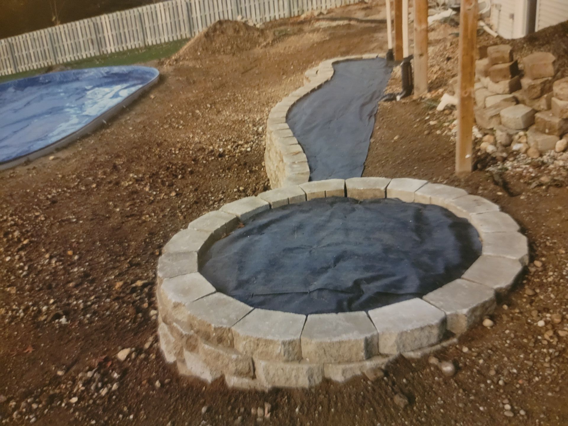 A circle of bricks used to form edging for flower bed