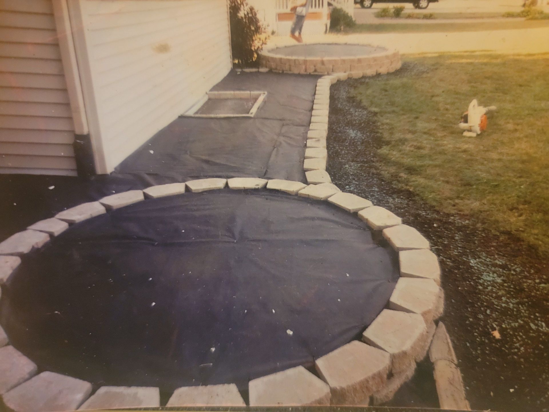 A black and white photo of a paver edging retaining wall
