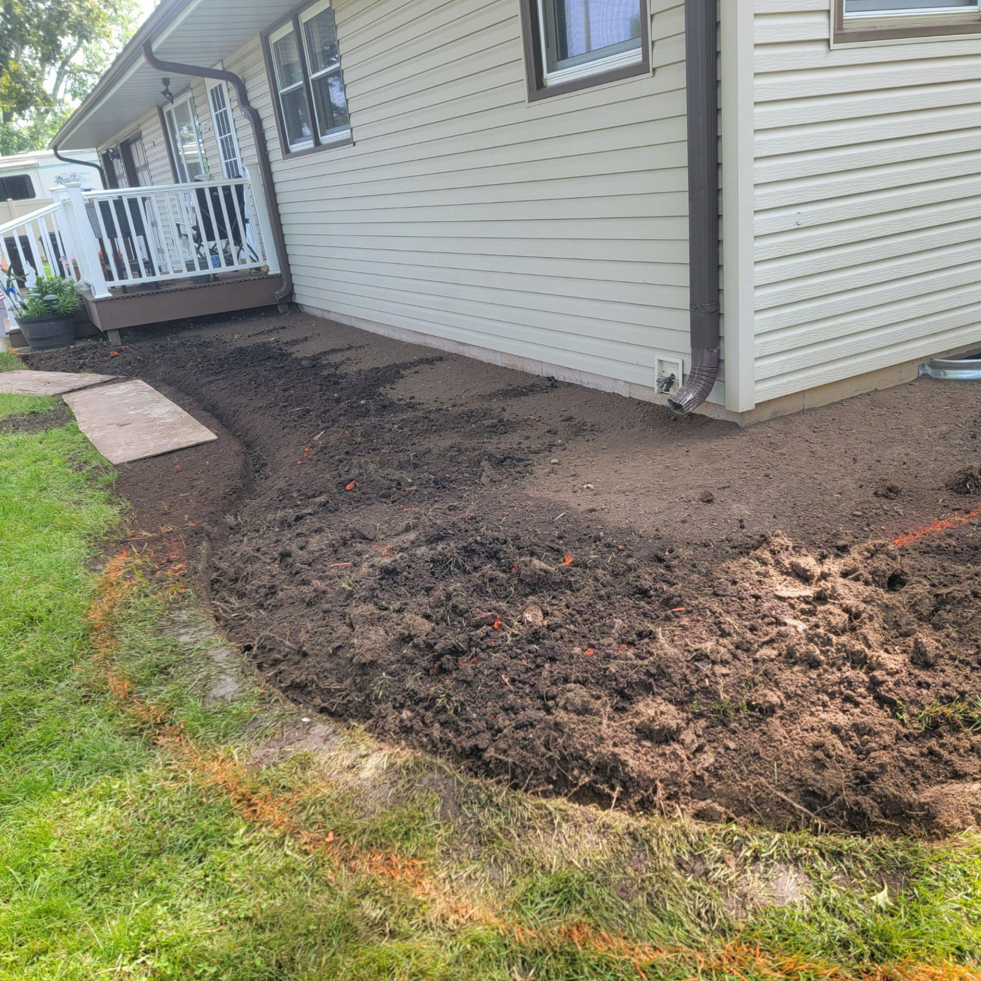 A house with a lot of dirt in front of it.